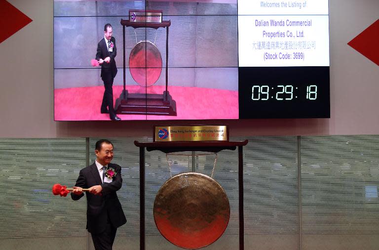 Wang Jianlin, CEO of Dalian Wanda Commercial Properties Co, strikes the gong to launch the firm's IPO at the Hong Kong stock exchange on December 23, 2014