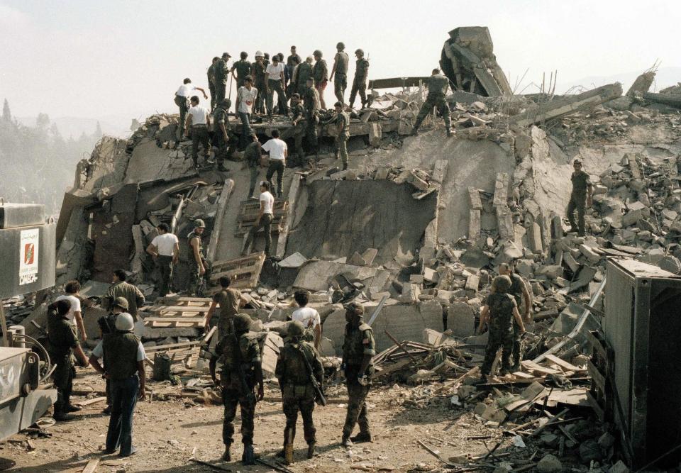 Rescue workers remove the body of a U.S. Marine from the rubble of the Marine Battalion headquarters at Beirut airport