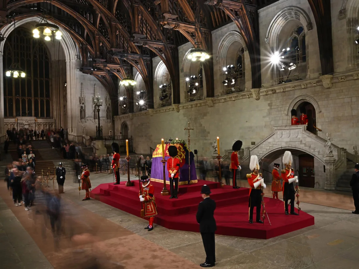 A royal guard collapsed in front of the Queen's coffin while standing watch over..