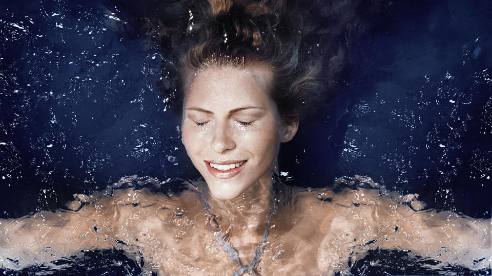 A woman relaxes in a pool