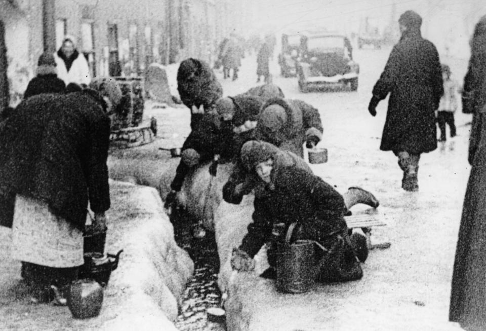 FILE - This file photo, taken in the winter months of 1942, shows citizens of Leningrad as they dig up water from a broken main, during the 900-day siege of the Russian city by German invaders.The Conference on Jewish Material Claims Against Germany that handles claims on behalf of Jews who suffered under the Nazis says the German government has agreed to extend compensation to Jewish survivors who endured the World War II siege of Leningrad and two other groups who had so far not received any monthly pensions. (AP Photo, File)