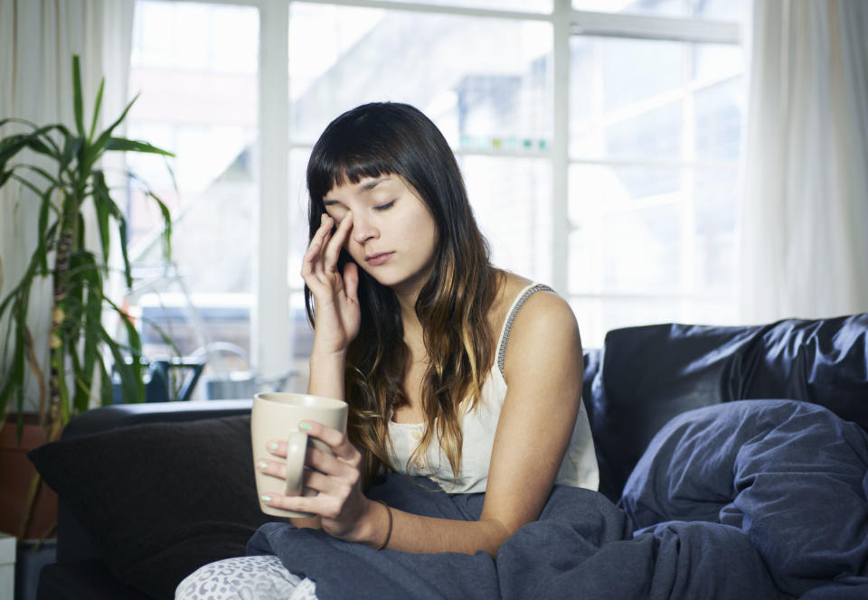 Girl looking tired with mug of tea. Source: Getty Images