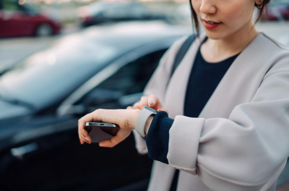 Young Asian woman checking time 