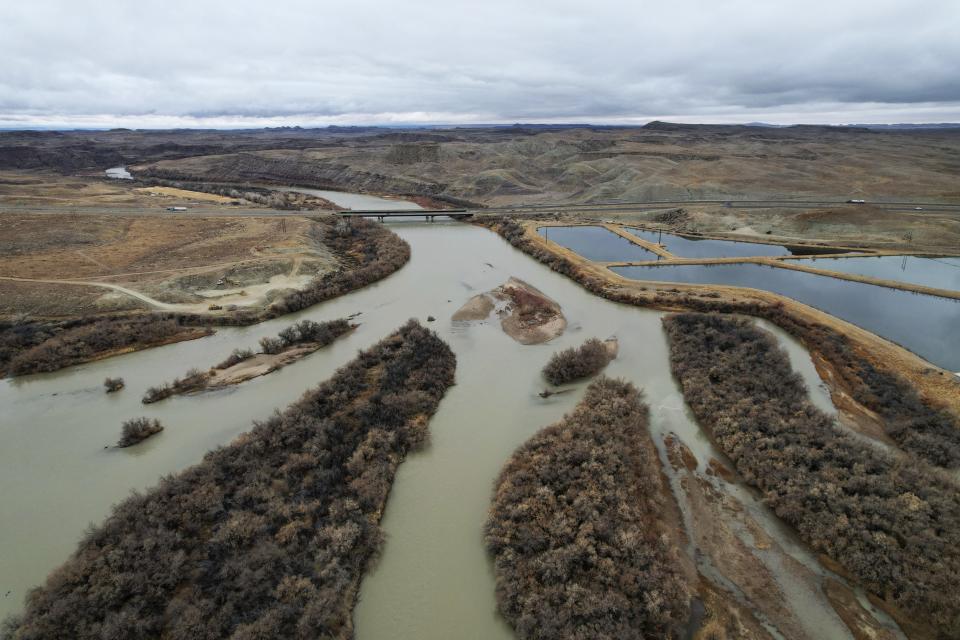 The Green River, a tributary of the Colorado River, flows on Thursday, Jan. 25, 2024, in Green River, Utah. An Australian company and its U.S. subsidiaries are eyeing a nearby area to extract lithium, metal used in electric vehicle batteries. The company has also applied for rights to freshwater from the Green River. (AP Photo/Brittany Peterson)