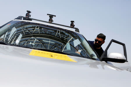 A man enters a Kia Soul, modified as an autonomous vehicle by the Imagry startup company, ahead of a driving demonstration near Shfayim, Israel April 17, 2018. REUTERS/Nir Elias