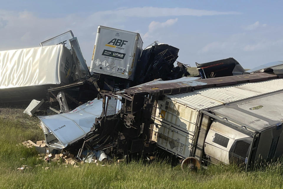 In this photo provided by Hill County Disaster and Emergency Services, freight cars from a BNSF Railway train are derailed east of Havre, Mont. on Friday, July 21, 2023. Local officials said 25 cars derailed but no one was injured. The cause is under investigation. (Amanda Frickel/Hill County Disaster and Emergency Services via AP)
