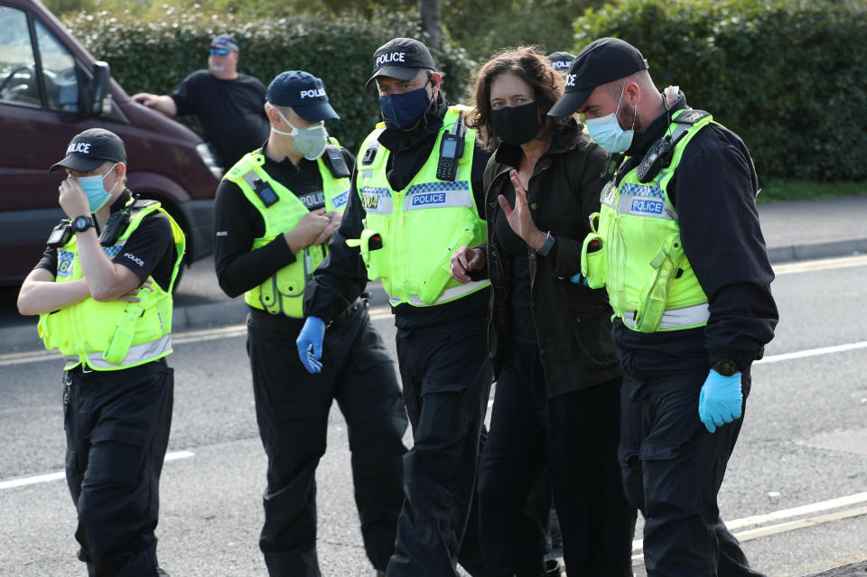 One protester is lead away by police outside the Newsprinters printing works at Broxbourne, Hertfordshire, other protesters use bamboo lock-ons and a van to continue to block the road. (Photo by Yui Mok/PA Images via Getty Images)