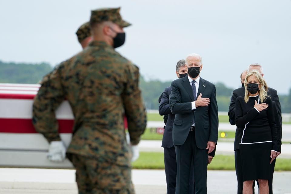 President Joe Biden and first lady Jill Biden watch a Marine Corps carry team move a transfer case containing the remains of Sgt. Johanny Rosario Pichardo, 25, of Lawrence, Mass., on Aug. 29, 2021, at Dover Air Force Base, Del.