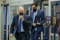 Sen. Mark Kelly, D-Ariz., adjusts his mask as he leaves the Senate subway on Capitol Hill in Washington, Tuesday, Aug. 3, 2021. (AP Photo/Amanda Andrade-Rhoades)