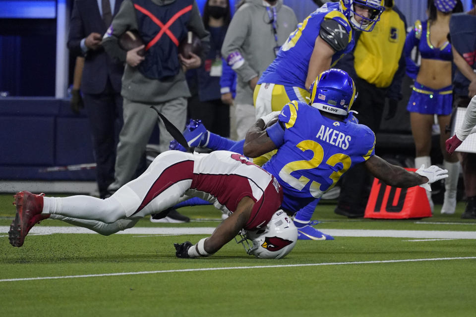 Arizona Cardinals safety Budda Baker, bottom, falls forward after tackling Los Angeles Rams running back Cam Akers (23) during the second half of an NFL wild-card playoff football game in Inglewood, Calif., Monday, Jan. 17, 2022. (AP Photo/Mark J. Terrill)