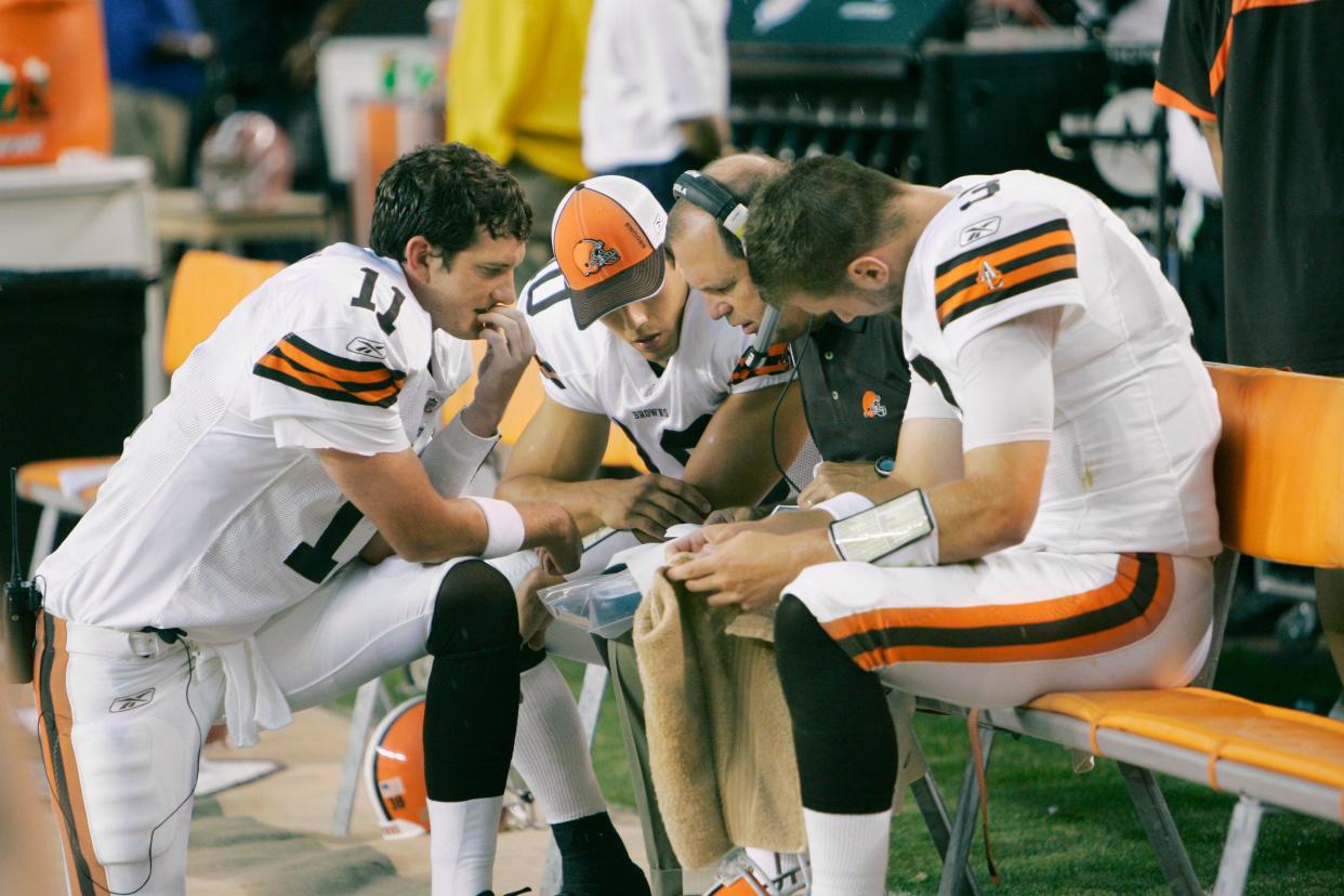 Cleveland Browns quarterbacks Ken Dorsey (11), Brady Quinn, second from left, and Derek Anderson, right, huddle with coach Rip Scherer during a preseason game against the New York Jets on Aug. 7, 2008, in Cleveland.