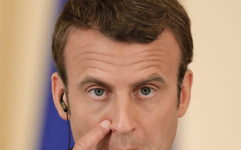 French President Emmanuel Macron touches his face during a joint press conference with Romanian counterpart Klaus Iohannis, in Bucharest, Romania, Thursday, Aug. 24, 2017.  - Credit: Vadim Ghirda/AP