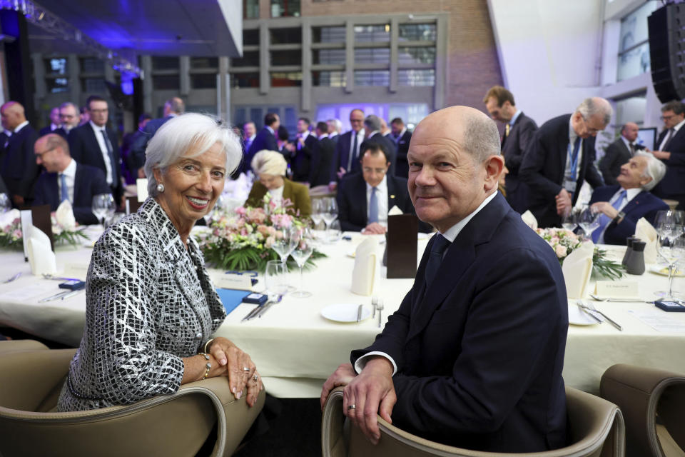 European Central Bank president Christine Lagarde, left, and German Chancellor Olaf Scholz sit at a table during a ceremony to celebrate the 25th anniversary of the European Central Bank, in Frankfurt, Germany, Wednesday May 24, 2023. (Kai Pfaffenbach/Pool via AP)