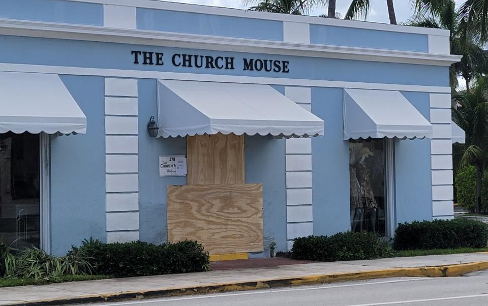 The front entrance of the Church Mouse is covered by plywood Wednesday after police say a 54-year-old Tennessee woman lost control of her Chevrolet SUV about 4 a.m. and careened into the building.