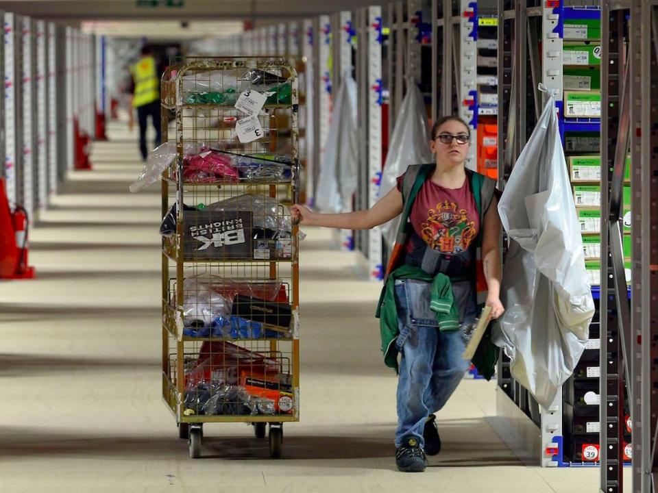 File photo dated 21/03/16 of staff in the warehouse during a tour of the Sports Direct headquarters in Shirebrook, Derbyshire, as Sports Direct founder Mike Ashley admitted that he paid workers below the minimum wage, also telling MPs that he has discovered