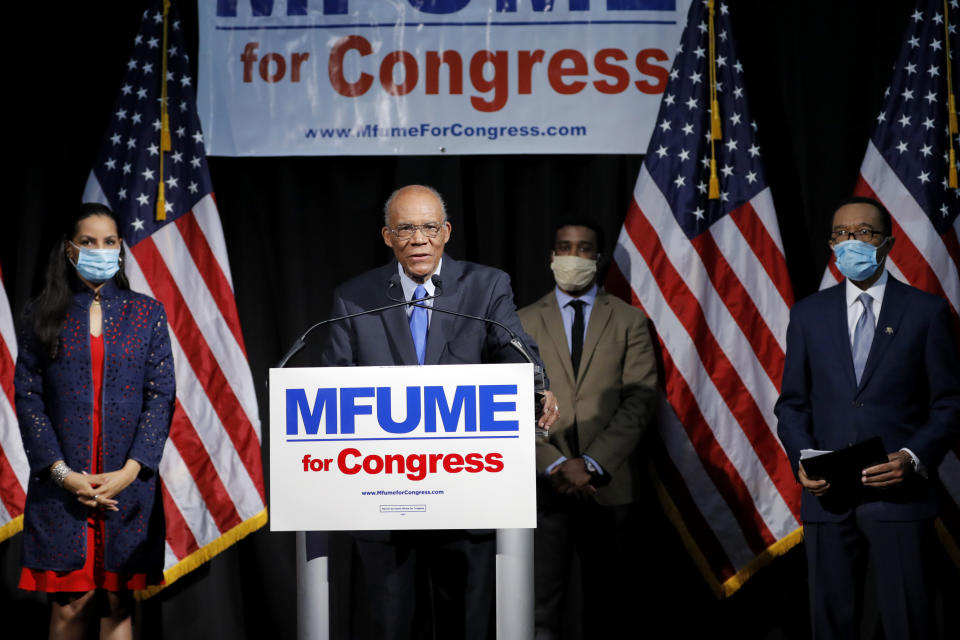 Larry Gibson, center left, political adviser for Democrat Kweisi Mfume, right, speaks as Mfume's wife, Tiffany Mfume, left, and their son, Chris Mfume, listen during an election night news conference after Mfume won the 7th Congressional District special election, Tuesday, April 28, 2020, in Baltimore. Mfume defeated Republican Kimberly Klacik to finish the term of the late Rep. Elijah Cummings, retaking a Maryland congressional seat Mfume held for five terms before leaving to lead the NAACP. The seat came open after Cummings died in October. (AP Photo/Julio Cortez)