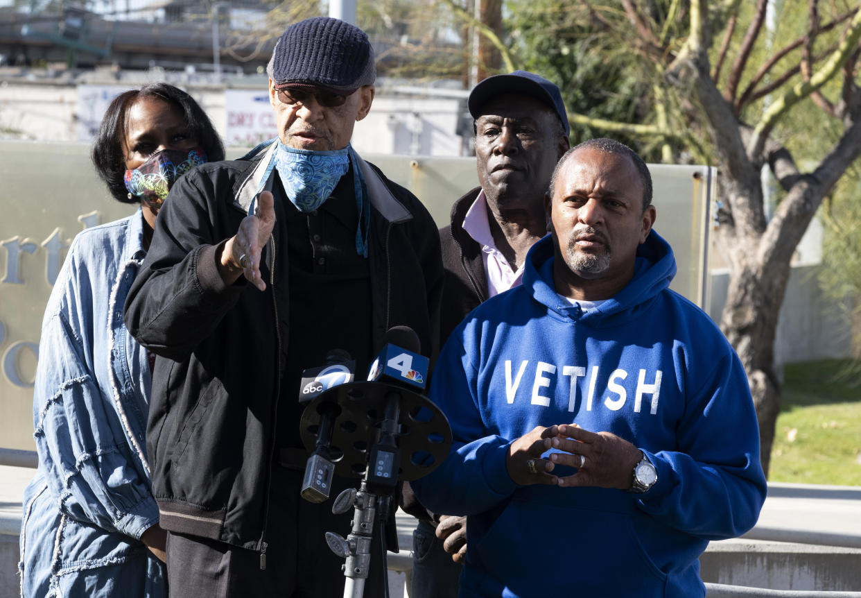 Civil rights activists Najee Ali, right and Los Angeles Urban Policy Roundtable President Earl Ofari Hutchinson address the media in front of the North Hollywood Police station in Los Angeles on Saturday, Jan. 2, 2021. They are calling for LAPD Chief Michel Moore to order the immediate arrest of the woman who they say lives in Los Angeles, and has reportedly been identified by NYPD sources as the woman caught on camera falsely accusing the 14-year-old son of jazz trumpeter Keyon Harrold of stealing her iPhone at a New York Hotel. New York Police have released a new video clip showing the woman trying to tackle the boy after falsely accusing him of stealing her phone at a New York City hotel. (AP Photo/Richard Vogel)