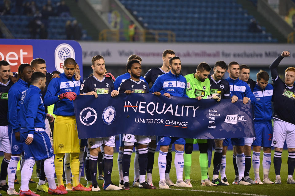 Millwall and Queens Park Rangers players held up a banner promoting equality before their game Tuesday in response to Saturday's Millwall fans booing kneeling. (Photo by Justin Setterfield/Getty Images)