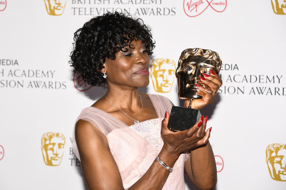 Rakie Ayola poses for photographers with her Best Supporting Actress award for her role in 'Anthony' backstage at the British Academy Television Awards in London, Sunday, June 6, 2021. (AP Photo/Alberto Pezzali)