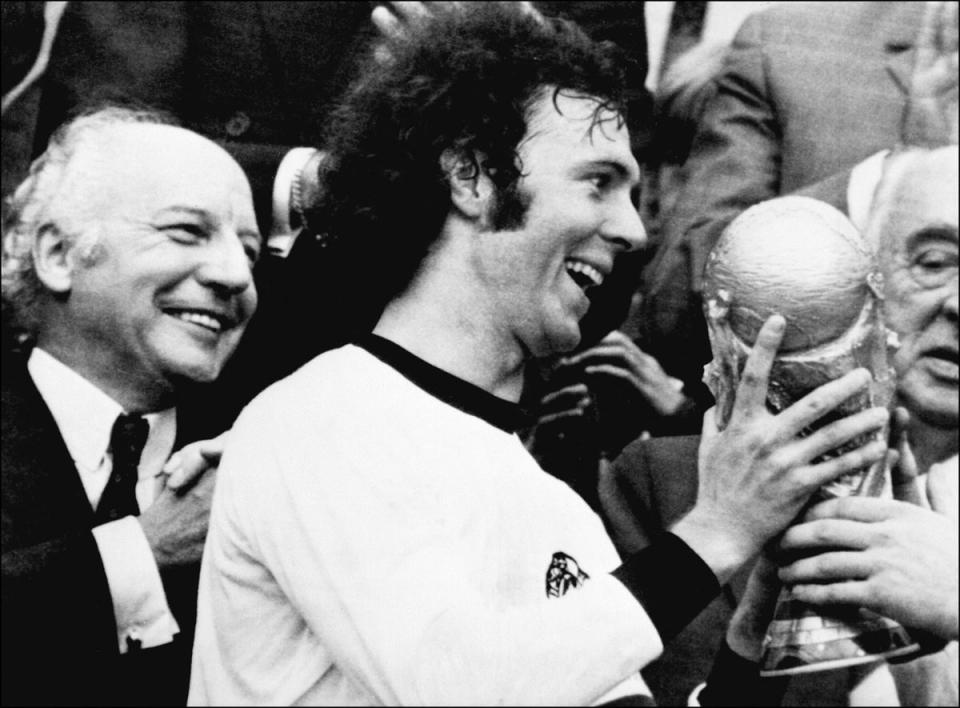 Germany captain Franz Beckenbauer with the World Cup trophy after a 2-1 victory over Netherlands in 1974 (AFP via Getty Images)