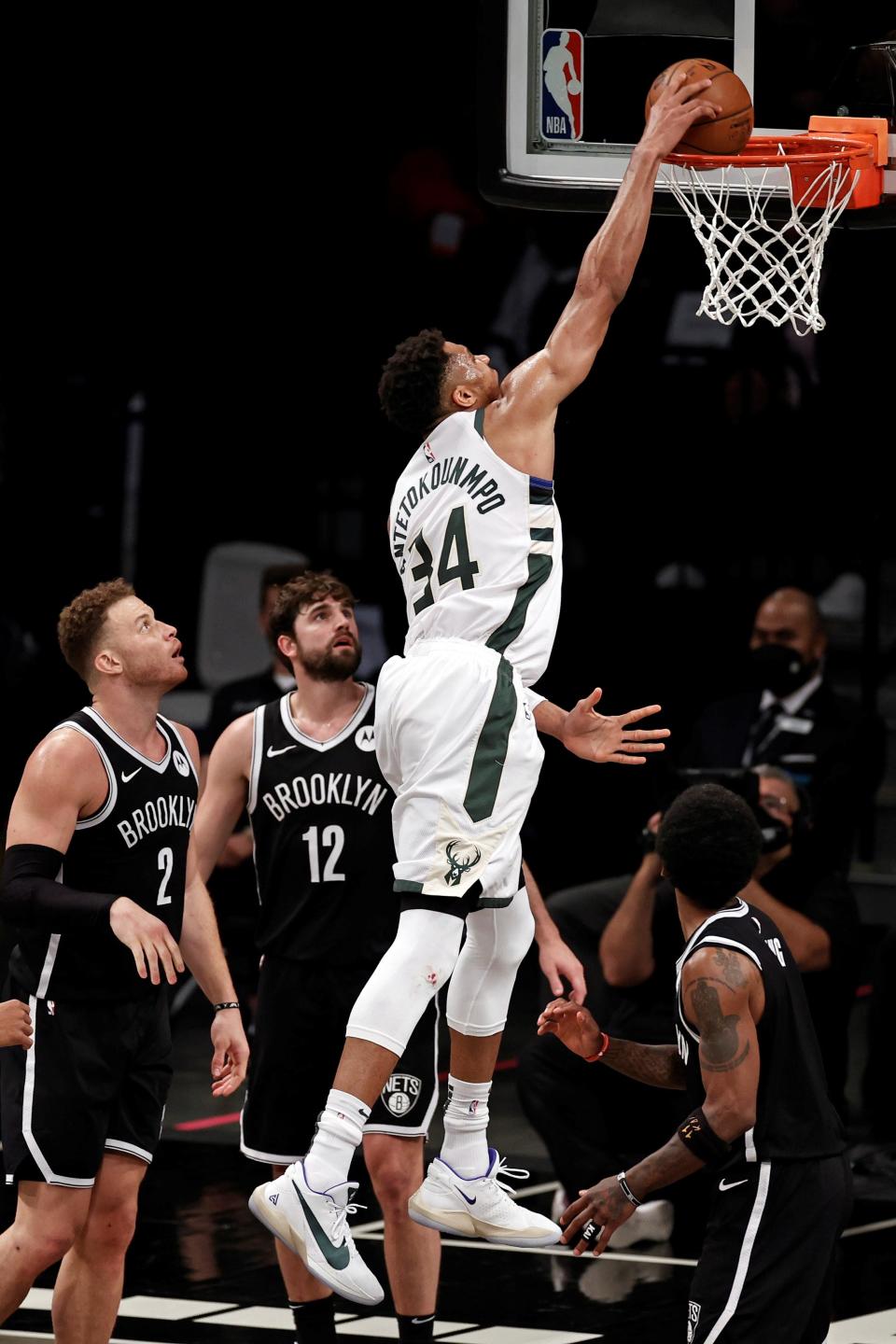 Milwaukee Bucks forward Giannis Antetokounmpo (34) dunks the ball over Brooklyn Nets forward Joe Harris (12) during the second half of Game 1 of an NBA basketball second-round playoff series Saturday, June 5, 2021, in New York. (AP Photo/Adam Hunger) ORG XMIT: NYOTK