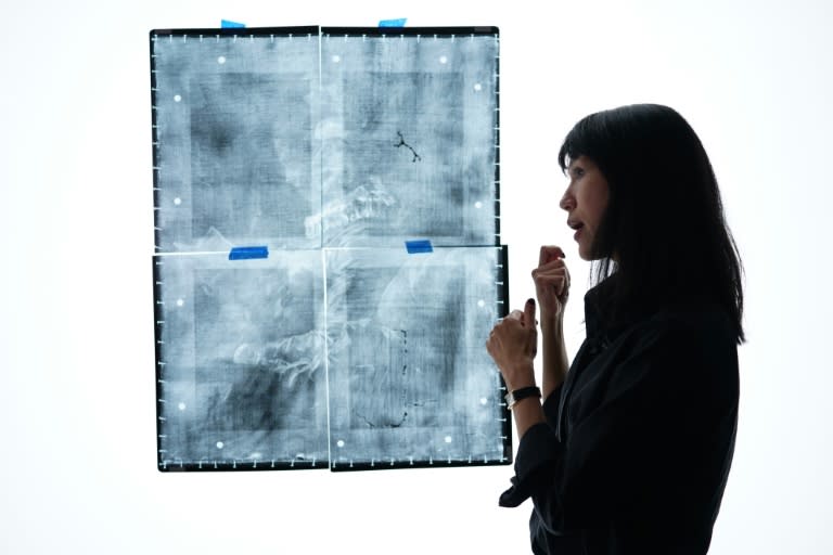 National Gallery of Art assistant curator of French paintings Yuriko Jackall, next to an x-radiograph of "Young Girl Reading"