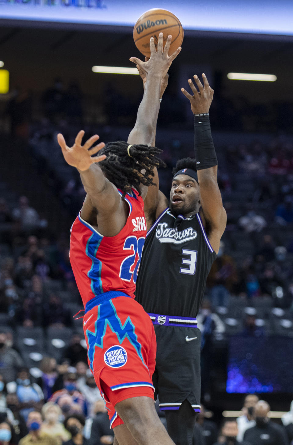 Sacramento Kings guard Terence Davis (3) scores a 3-point basket over Detroit Pistons center Isaiah Stewart (28) during the second half of an NBA basketball game in Sacramento, Calif., Wednesday, Jan. 19, 2022. The Pistons won 133-131. (AP Photo/José Luis Villegas)