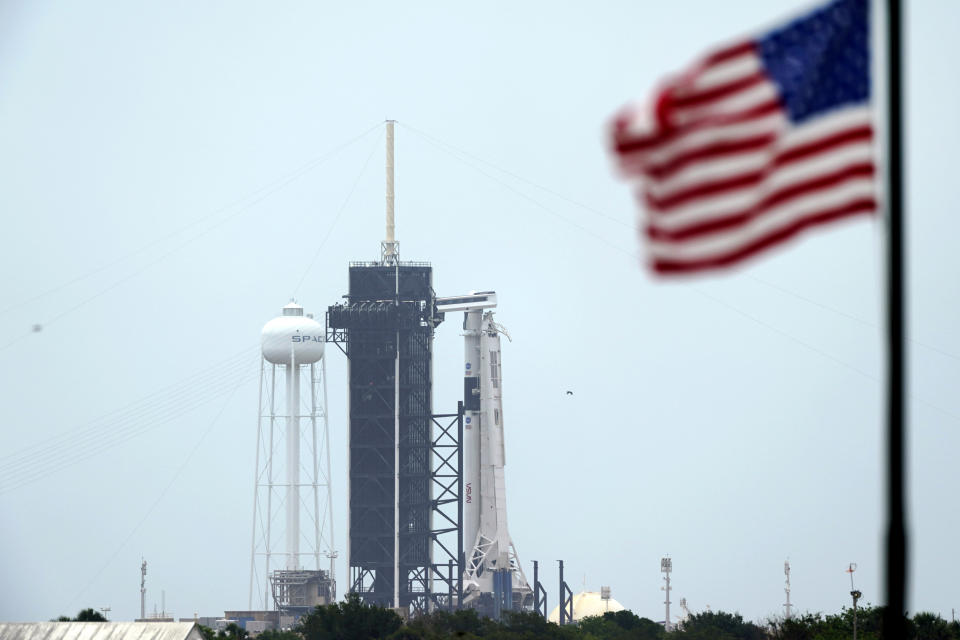 The SpaceX Falcon 9, with the Crew Dragon spacecraft on top of the rocket, sits on Launch Pad 39-A Monday, May 25, 2020, at Kennedy Space Center, Fla. Two astronauts will fly on the SpaceX Demo-2 mission to the International Space Station scheduled for launch on May 27. (AP Photo/David J. Phillip)