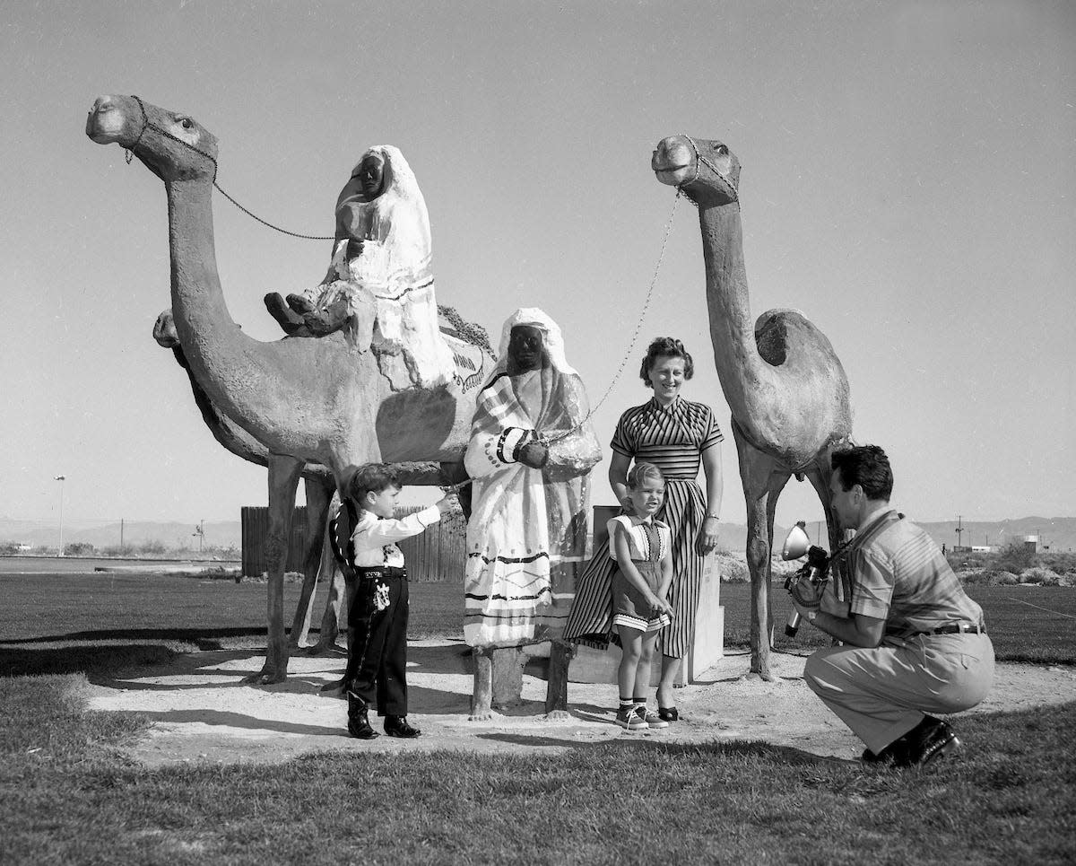 A family has their photo with the Sahara Hotel camels March 15, 1954. (Las Vegas News Bureau Collection, LVCVA Archive)