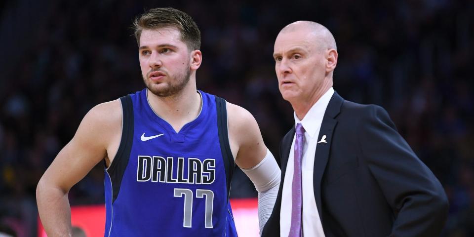 Luka Doncic and Rick Carlisle talk during a game in 2019.