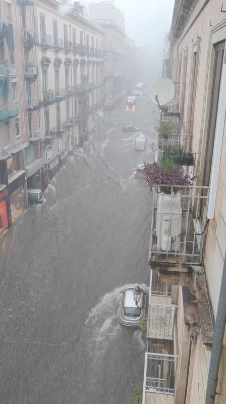 Flood sweeps through a street in the Sicilian city of Catania