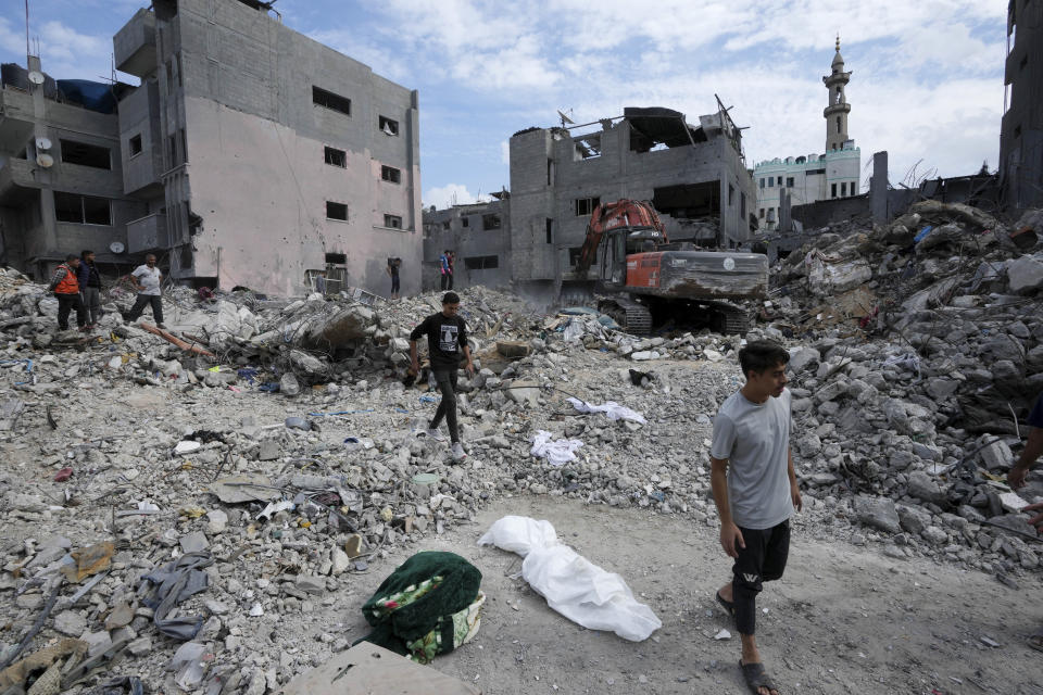 Palestinians recover the bodies of the al Meghari family killed in the Israeli bombardment of the Gaza Strip in Bureij refugee camp, Gaza Strip, Tuesday, Nov. 14, 2023. U.N. humanitarian monitors say at least 2,700 people, including 1,500 children, are missing and believed buried under the rubble. (AP Photo/Adel Hana)