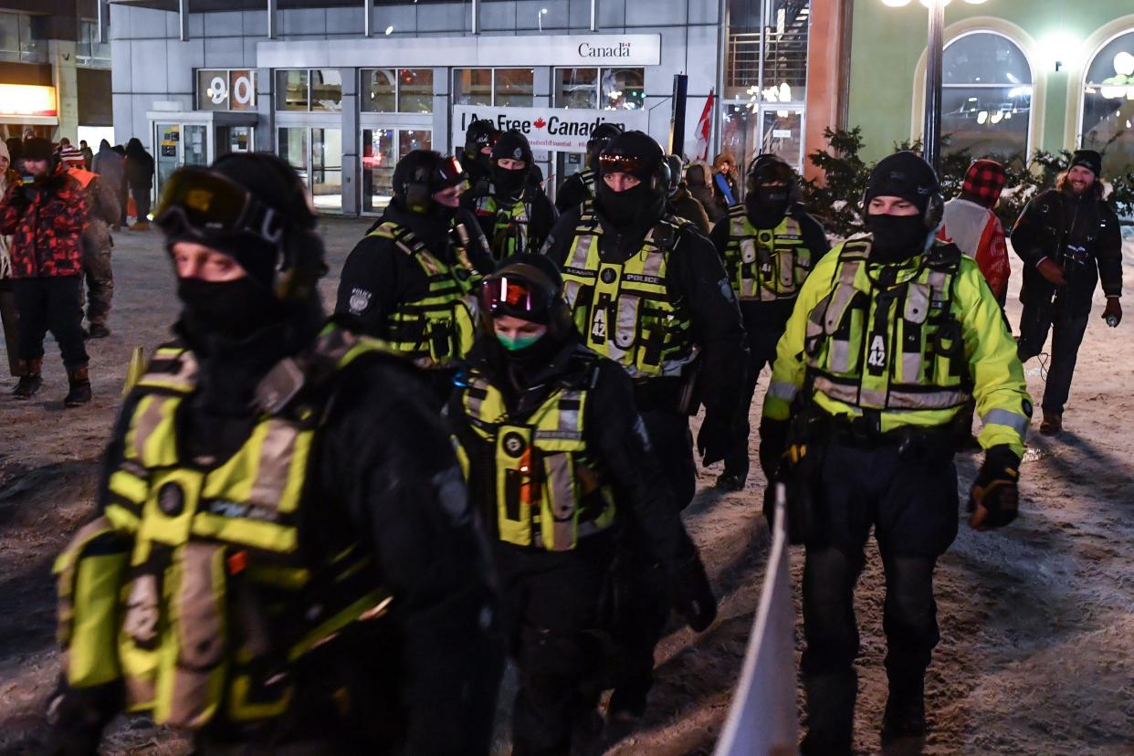 Canadian police march towards Wellington Street on February 5, 2022 in Ottawa, Canada as truckers continue to protest vaccine mandates.