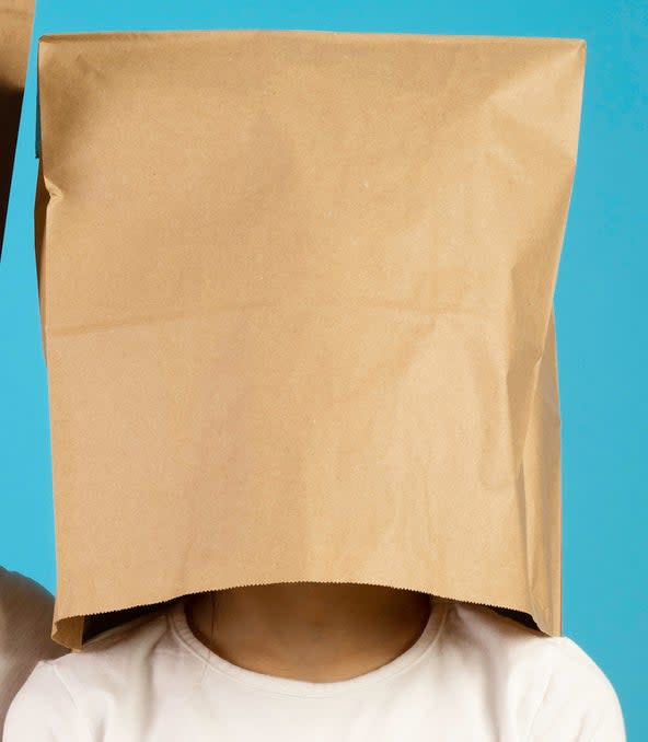 a kid with a paper bag over their head