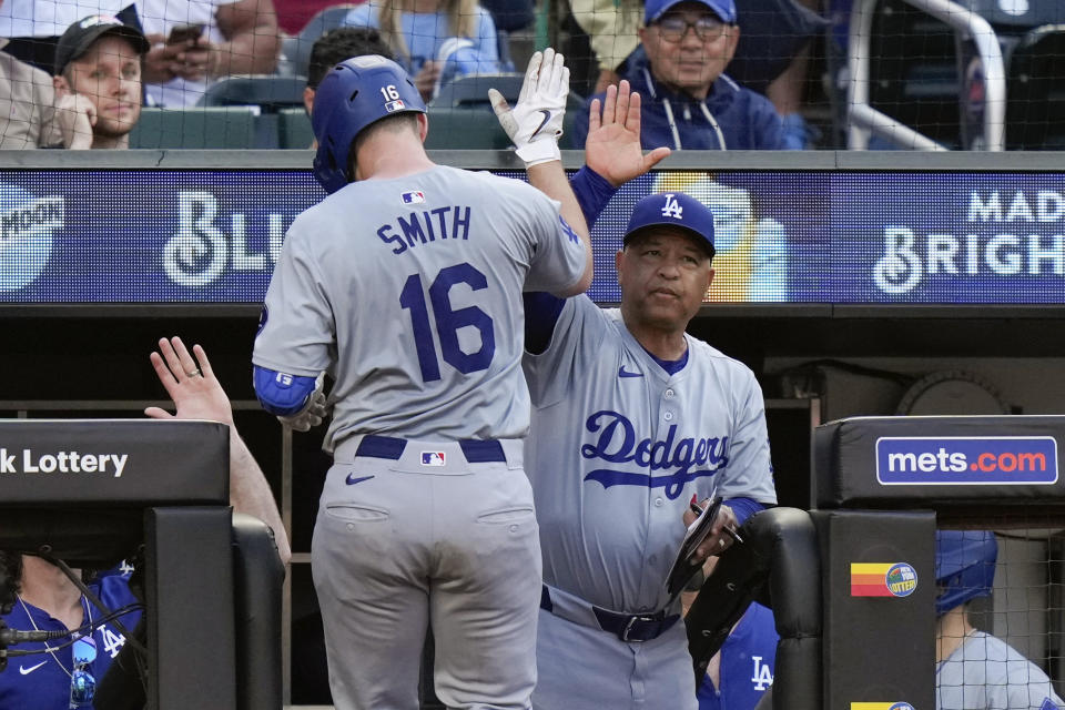 Los Angeles Dodgers manager Dave Roberts, right, celebrates with Will Smith, left, after Smith hit a home run during the eighth inning of a baseball game against the New York Mets, Wednesday, May 29, 2024, in New York. (AP Photo/Frank Franklin II)