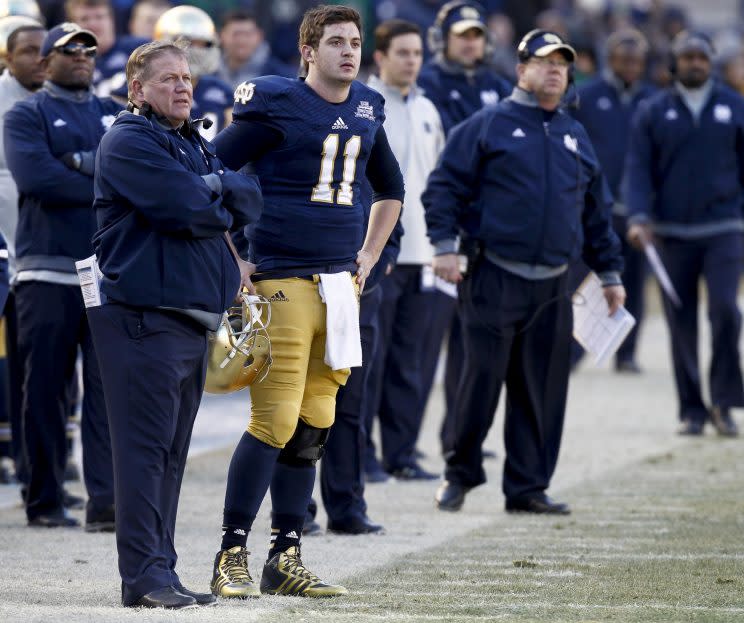 Tommy Rees (No. 11) is returning to Notre Dame to coach quarterbacks for Brian Kelly (left). (Getty)