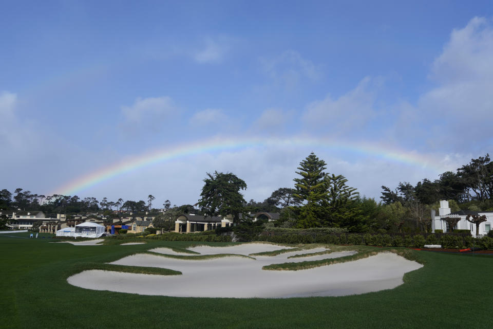 A rainbow is shown over a bunker on the 18th fairway at Pebble Beach Golf Links before the scheduled final round of the AT&T Pebble Beach National Pro-Am golf tournament in Pebble Beach, Calif., Sunday, Feb. 4, 2024. (AP Photo/Ryan Sun)