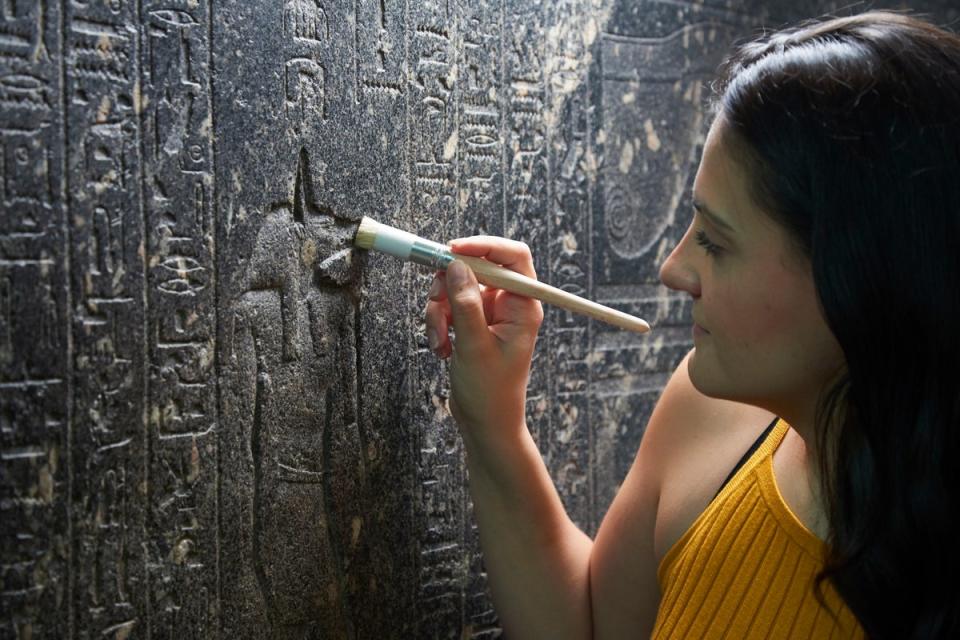 Senior Conservator, Stephanie Vasiliou, cleans ‘The Enchanted Basin’, sarcophagus of Hapmen, 600 BC (The Trustees of the British Museum)