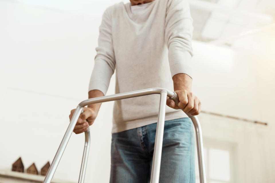 Useful equipment. Close up of a professional walking frame being used by a nice old man for walking