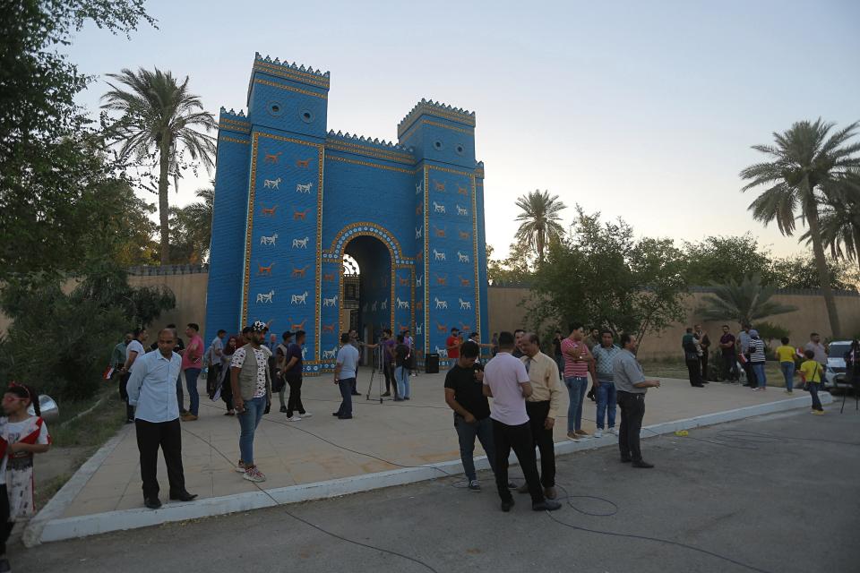 People visit the archaeological site of Babylon, Iraq, Friday, July 5, 2019. Iraq on Friday celebrated the UNESCO World Heritage Committee's decision to name the historic city of Babylon a World Heritage Site in a vote held in Azerbaijan's capital, years after Baghdad began campaigning for the site to be added to the list. (AP Photo/Anmar Khalil)