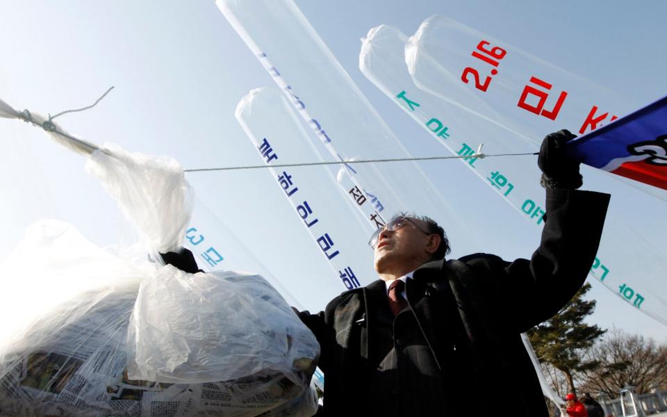 Anti-North Korea activists and North Korean defectors preparing to release balloons in Paju - Reuters