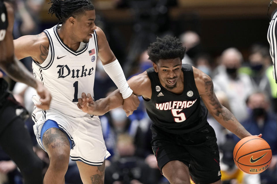 Duke guard Trevor Keels (1) guards North Carolina State guard Thomas Allen (5) during the first half of an NCAA college basketball game in Durham, N.C., Saturday, Jan. 15, 2022. (AP Photo/Gerry Broome)
