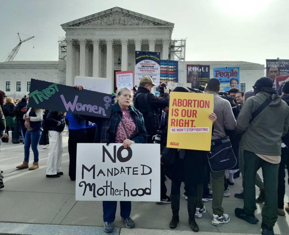 A woman holding up signs