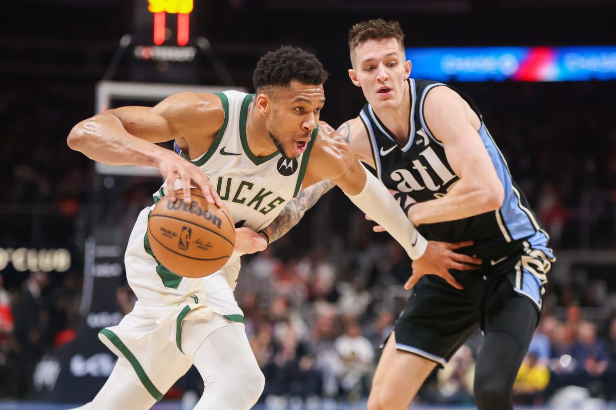 Bucks forward Giannis Antetokounmpo drives on Hawks guard Vit Krejci in the second quarter Saturday night in Atlanta.