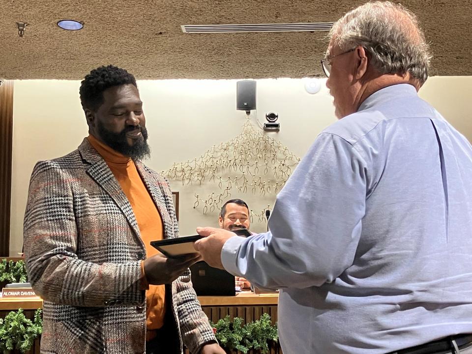 Outgoing Mansfield City Councilman Alomar Davenport (l) receives recognition at Tuesday night's meeting from fellow Councilman Phil Scott.