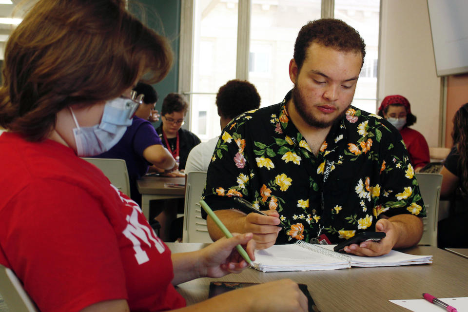 Angel Hope works on a math problem, part of an intense six-week summer bridge program for students of color and first-generation students at the University of Wisconsin, in Madison, Wis., July 27, 2022. Hundreds of thousands of recent graduates are heading to college this fall after spending more than half their high school careers dealing with the upheaval of a pandemic. Hope says he didn't feel ready for college after online classes in high school caused him fall behind but says the bridge classes made him feel more confident. (AP Photo/Carrie Antlfinger)