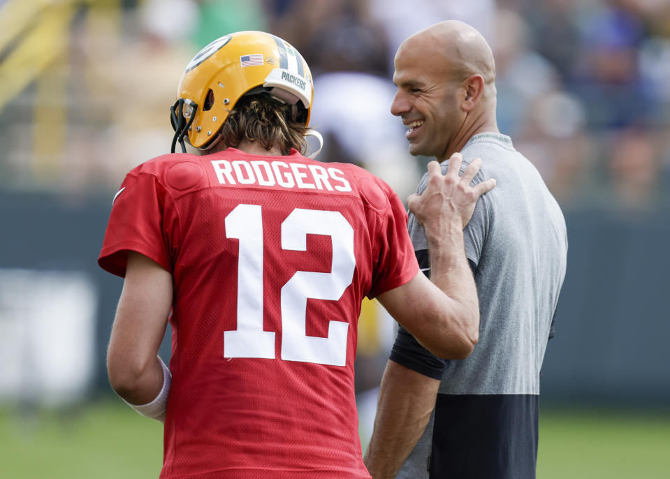 Green Bay Packers quarterback Aaron Rodgers and New York Jets head coach Robert Saleh share a laugh during a joint NFL football training camp practice Wednesday, Aug. 18, 2021, in Green Bay, Wis. (AP Photo/Matt Ludtke)