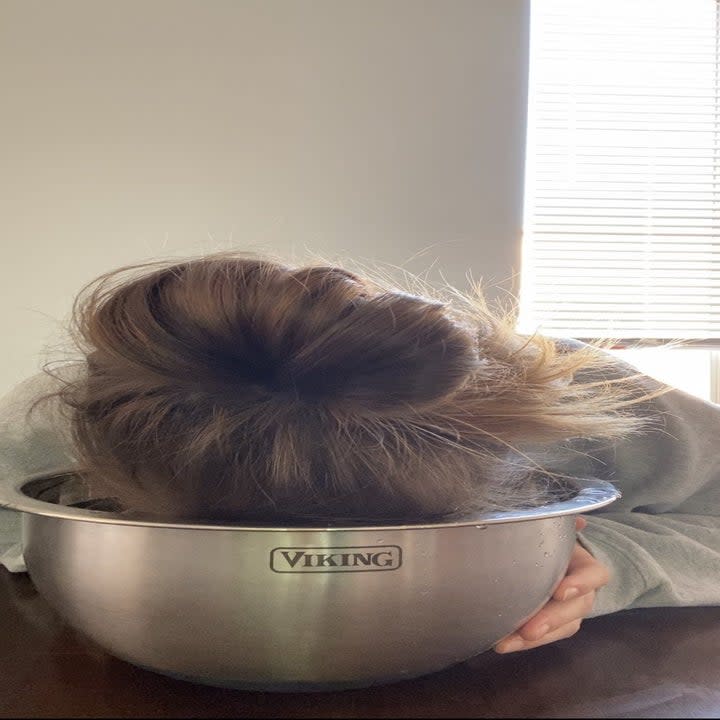 Shelby dunking her face in a bowl of cold water