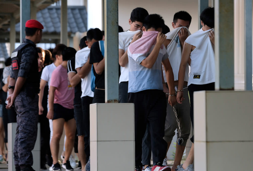 Some of the Chinese nationals who were arrested on suspicion of being involved in an illegal online scam are seen at the Sessions Court in Sepang December 13, 2019. — Bernama pic