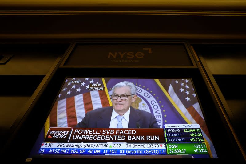 Traders react to Fed rate announcement on the floor of the NYSE in New York